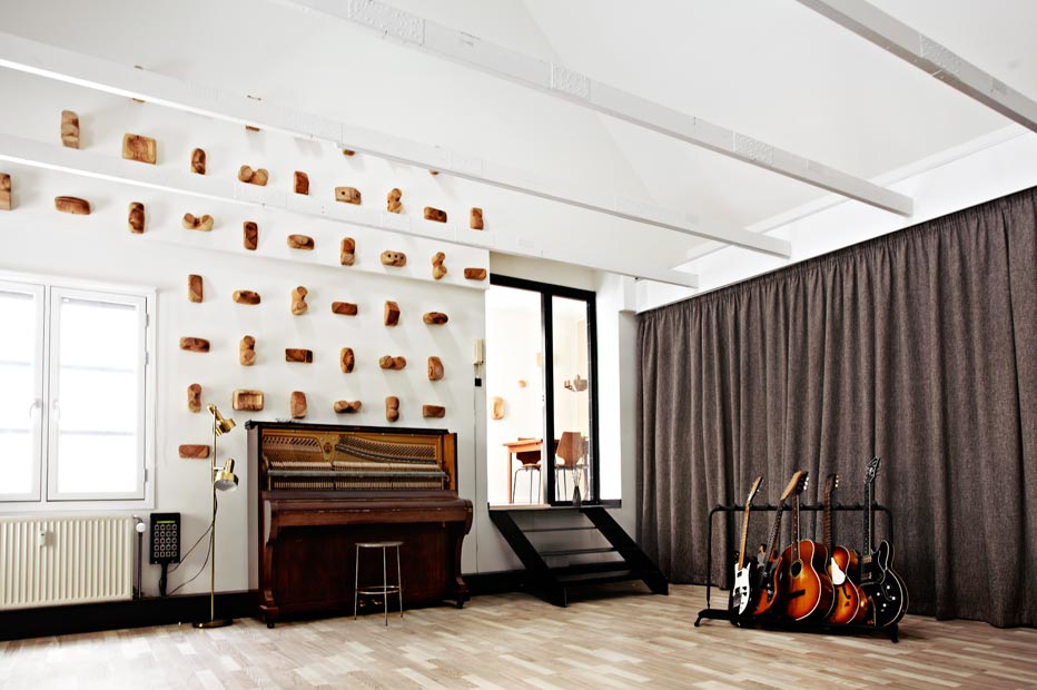 Music studio recording room with piano, guitars and stairs