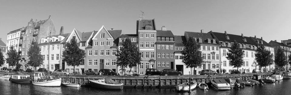 Christianshavn seen from the canal. Picturesque houses in multiple colors. Boats in the canal 